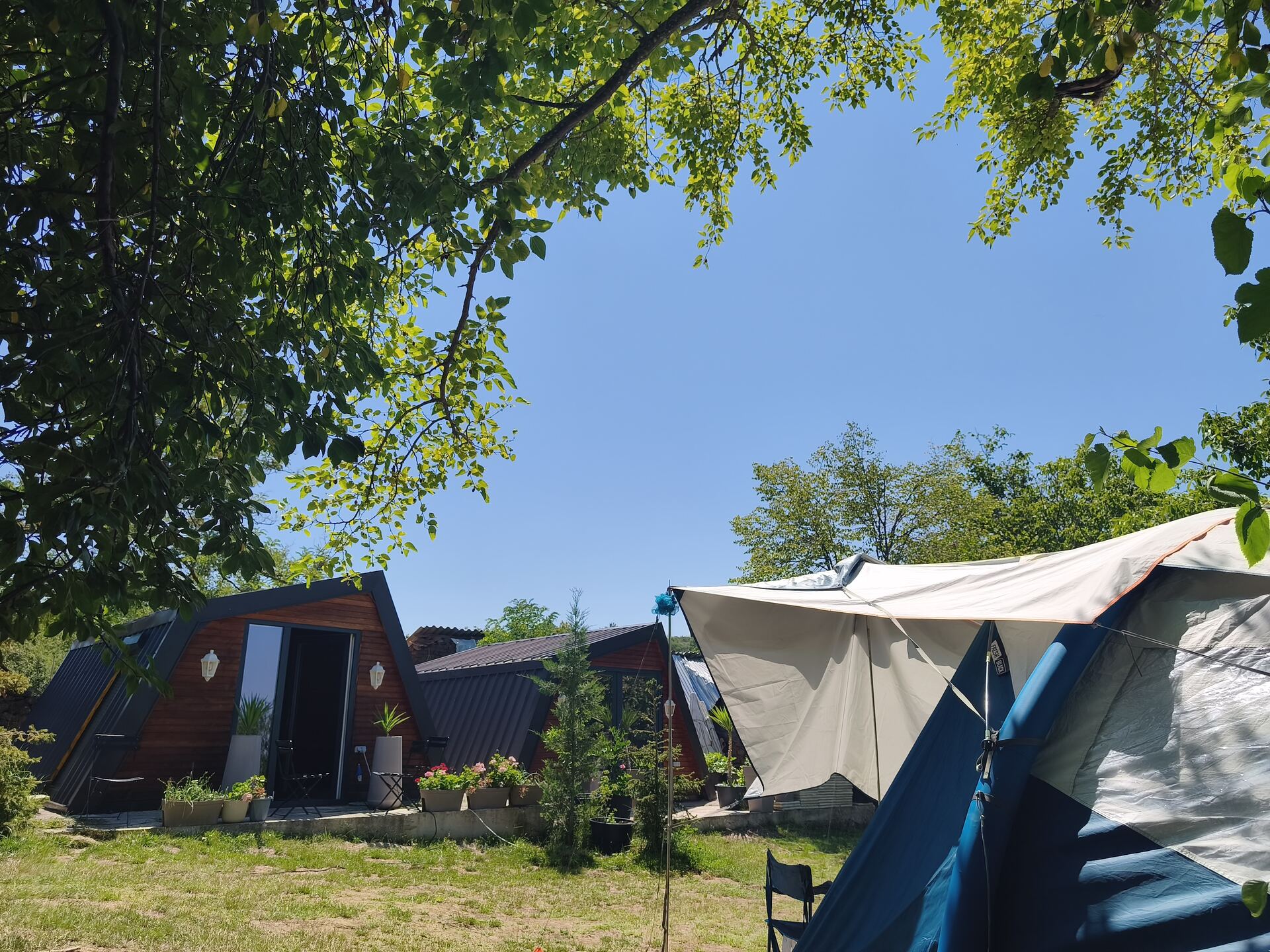 Glamping bungalows and tent camping pitch side by side, Kosovo